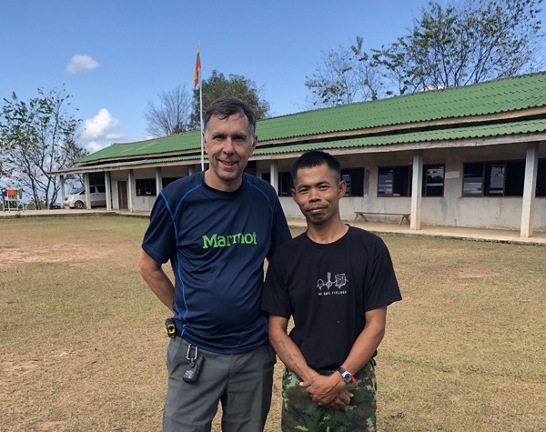Two men outside a remote medical clinic in Asia